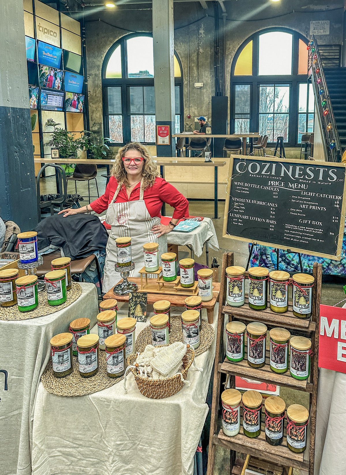 Owner standing behind her vendor booth. 